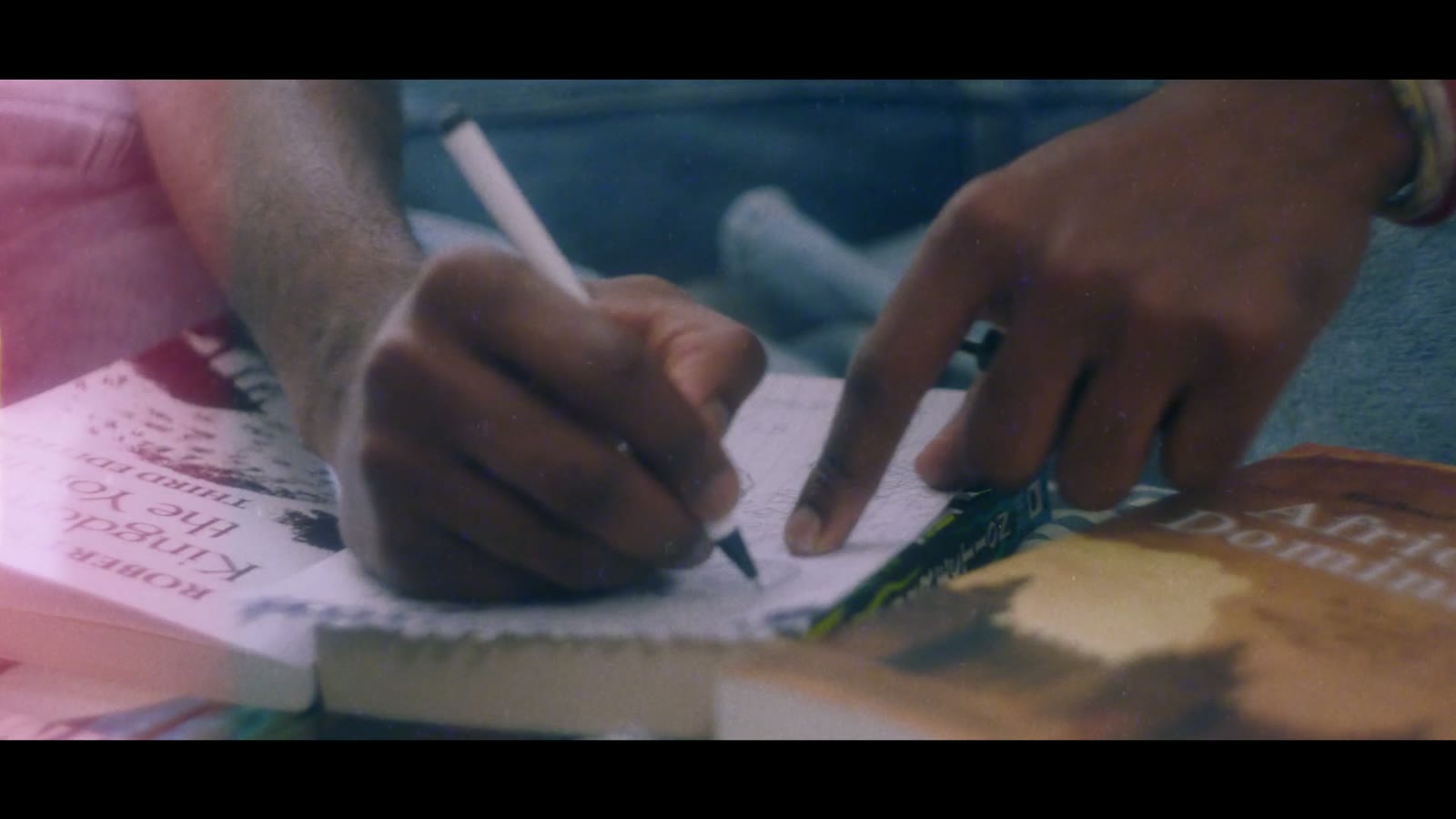 Still from Brothers Adelekan: the brothers drawing a page of their graphic novel together